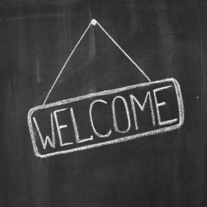 Welcome written on a black chalkboard