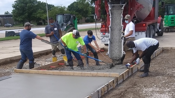 students spreading cement