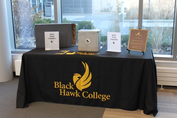 time capsules, plaque & pennant on table