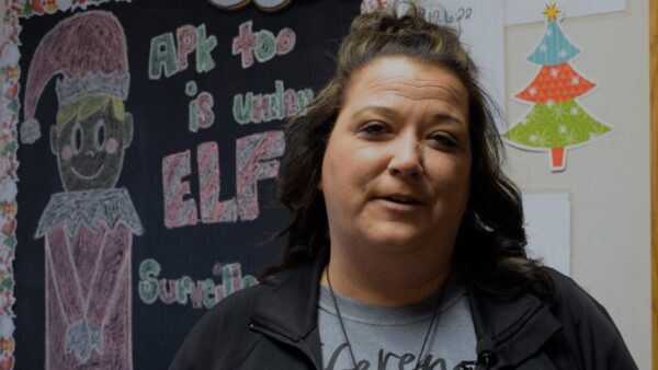 woman standing in front of chalkboard