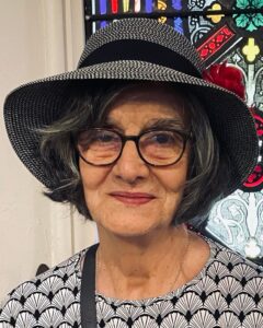 head & shoulders shot of Dee Canfield wearing hat and glasses