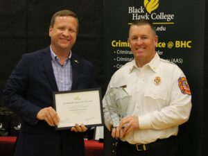 college president presenting award to fire chief