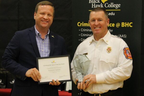 college president presenting award to fire chief