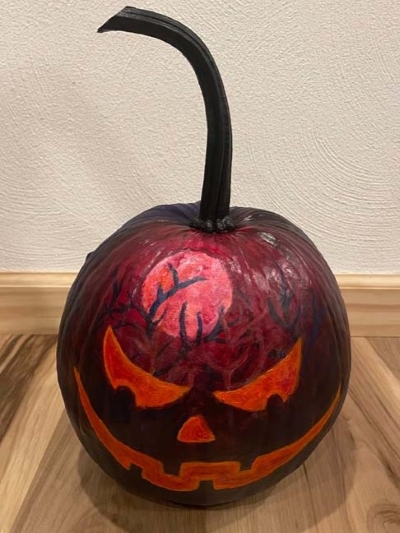 pumpkin painted red and black to look like scary forest