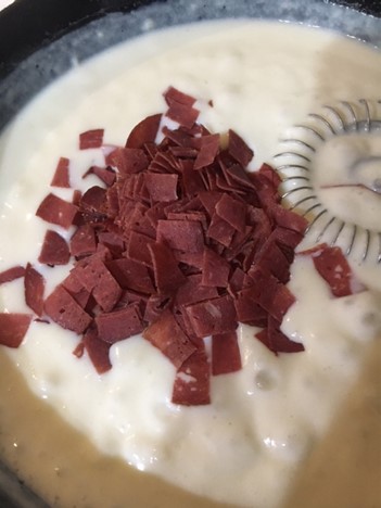 mixer in pan with chipped beef added into the mixer.