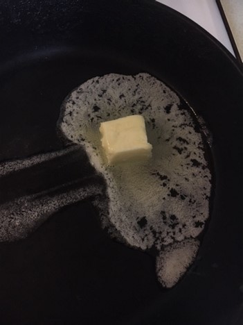 Pan with melting butter in it.