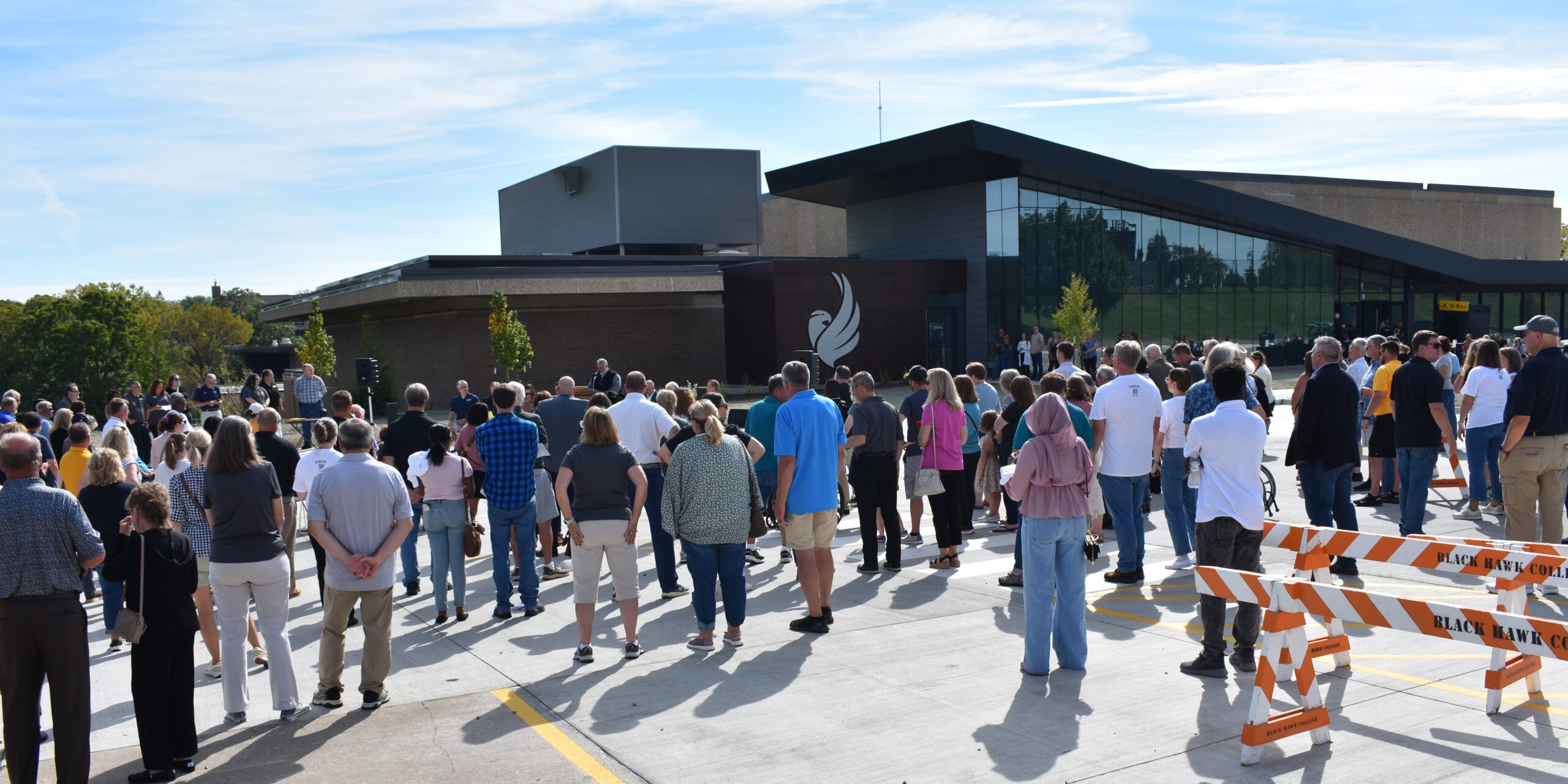 exterior view of Building 3 from the parking lot with large group of people