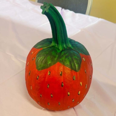 pumpkin painted to look like a strawberry