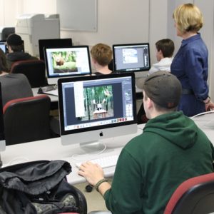 Student looking at a computer screen in a computer lab