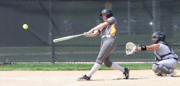 softball player hitting ball