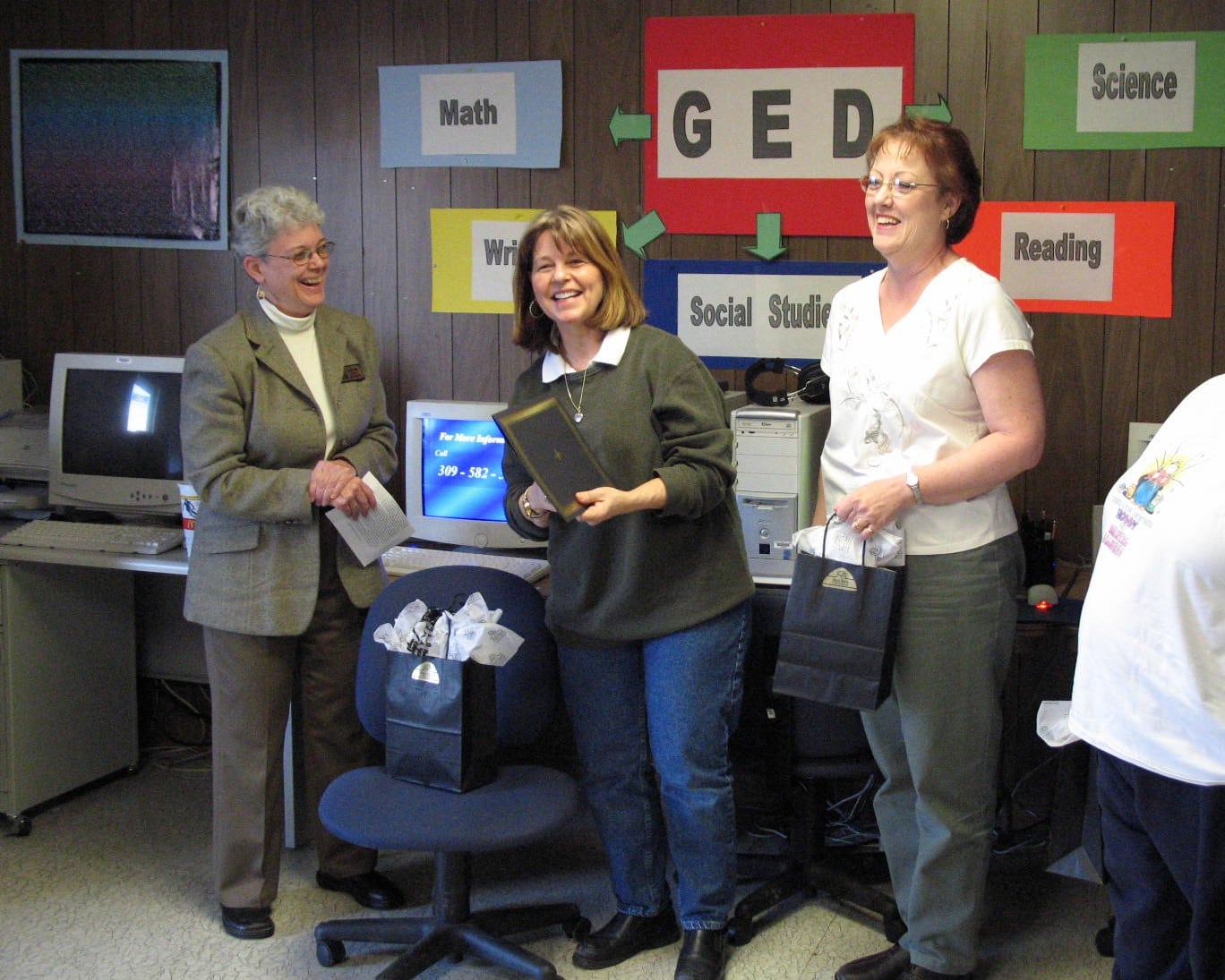 3 people laughing in GED classroom