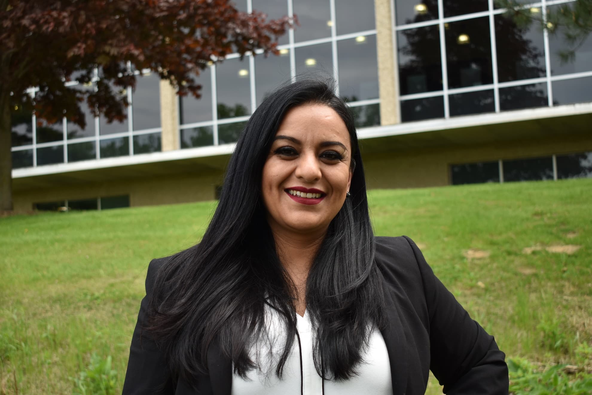 smiling woman standing in front of a building