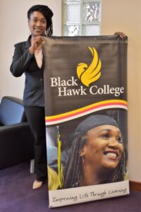 BHC graduate Tamica Reynolds holding large BHC sign