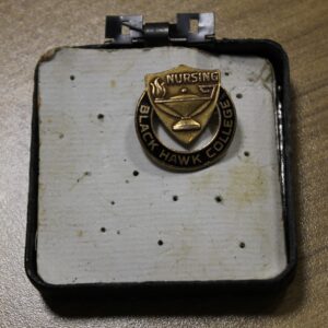 James Cobin's 1976 Black Hawk College nursing pin in holder