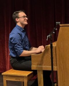 student playing upright piano