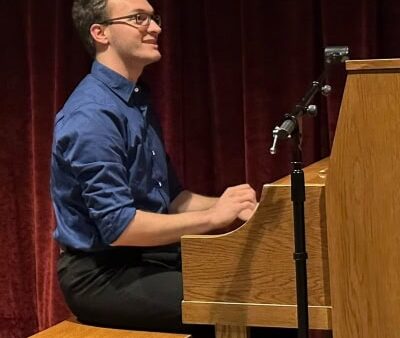 student playing upright piano