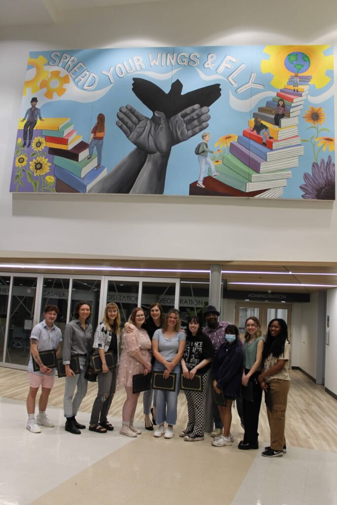 Art students in front of the mural
