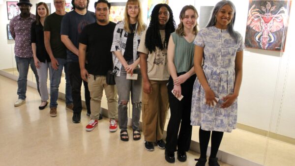 9 people standing in front of ArtSpace Gallery