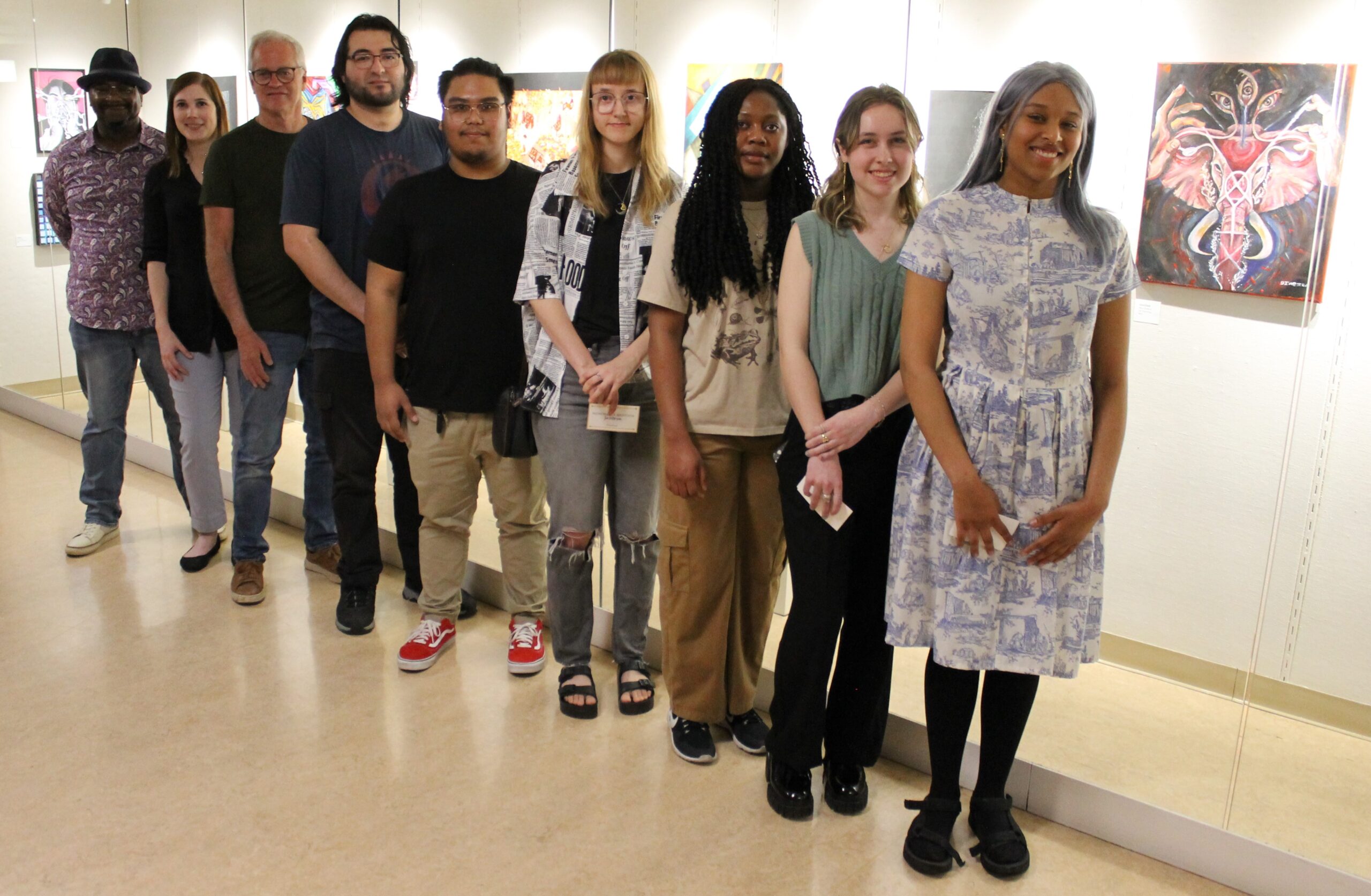 9 people standing in front of ArtSpace Gallery