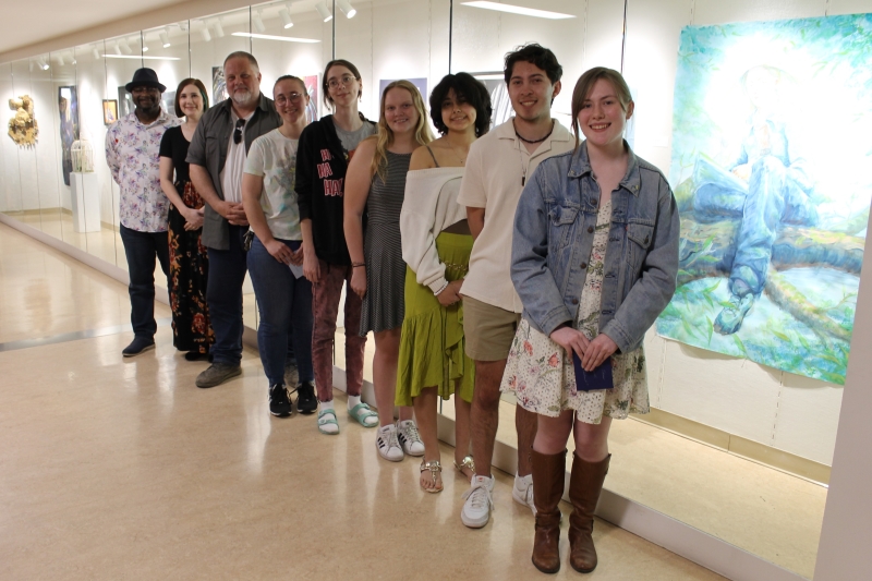 9 people standing in front of ArtSpace Gallery