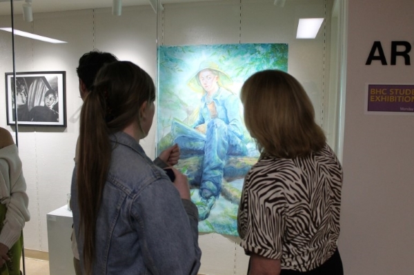 2 people with backs to camera looking at painting in ArtSpace Gallery