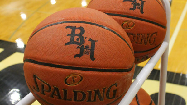 2 Basketballs in a Black Hawk Gymnasium