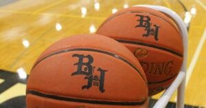 2 Basketballs in a Black Hawk Gymnasium