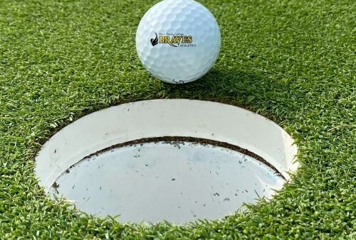 BHC Braves golf ball on edge of cup on the green