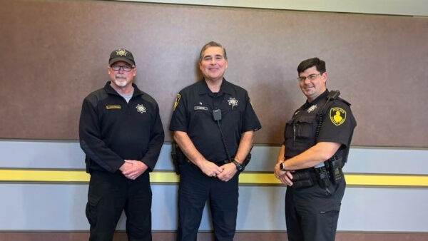 Three male officers of the Black Hawk Police Department pose for a picture together.