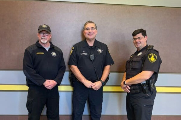 Three male officers of the Black Hawk Police Department pose for a picture together.