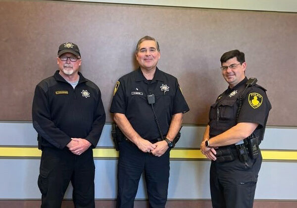 Three male officers of the Black Hawk Police Department pose for a picture together.