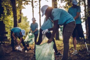 people picking up trash in the woods