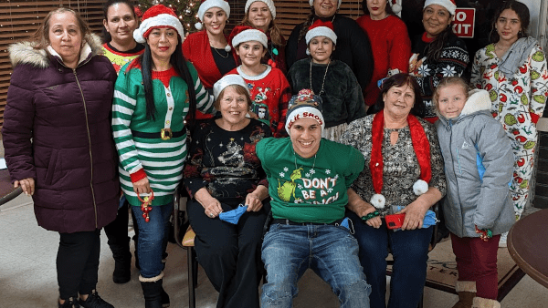 people wearing Christmas hats and smiling