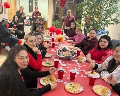 group of people seated at dinner tables decorated for Valentine's Day