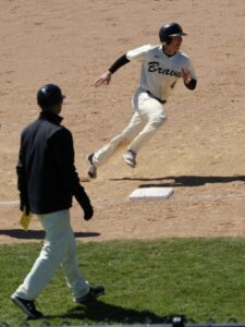 baseball player running over 3rd base