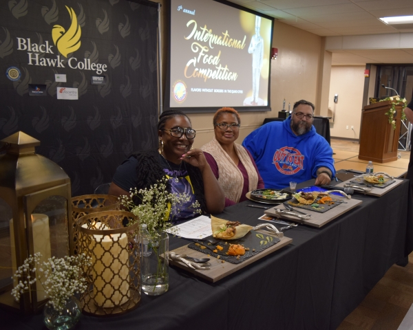 3 judges sitting at table with plates of food