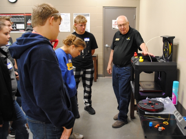 college instructor Paul Smith with group of students and 3D printer