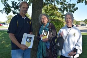 3 people standing under a tree