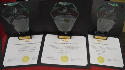 3 awards and 3 certificates on table