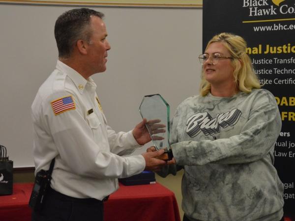 Deputy fire chief being handed award by BHC student