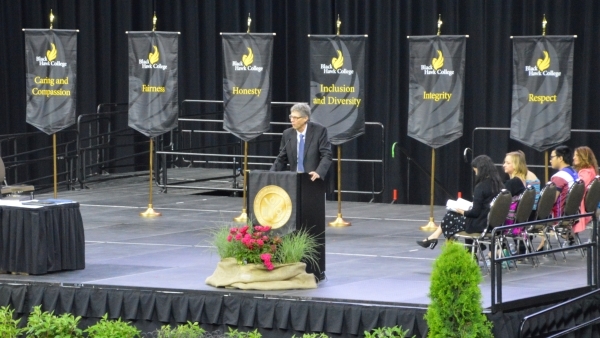 stage with banners and speaker at podium