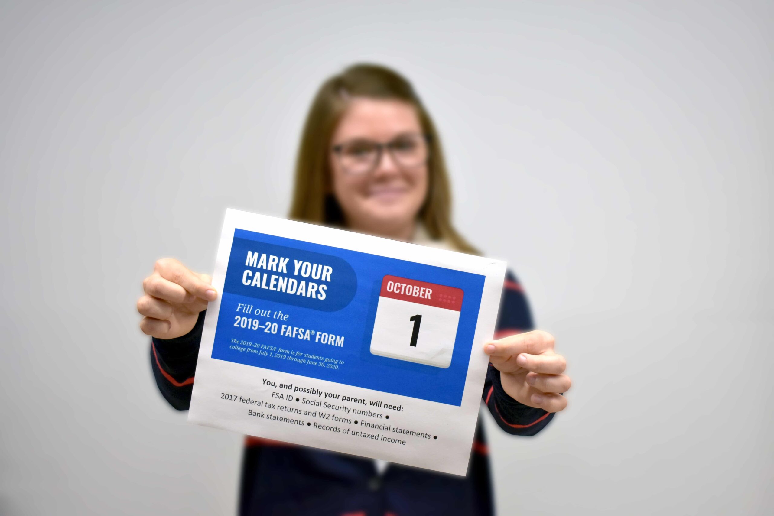 Girl holds up sign