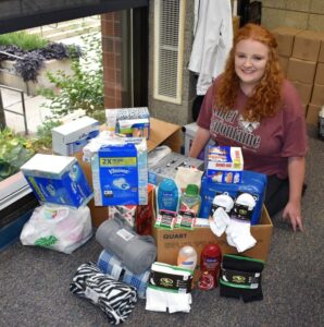 female student with donations for nursing home