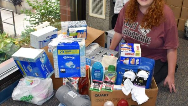 female student with donations for nursing home