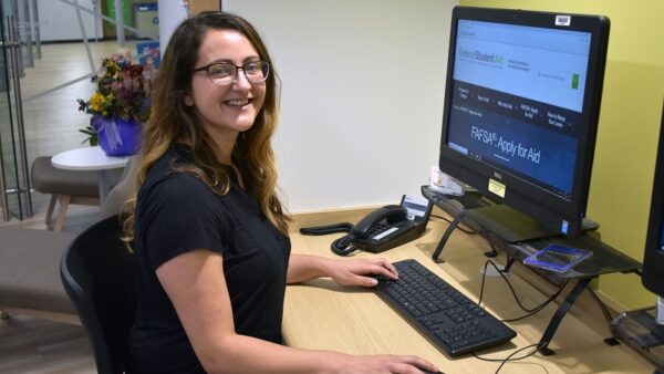 student at a computer with FAFSA website pulled up