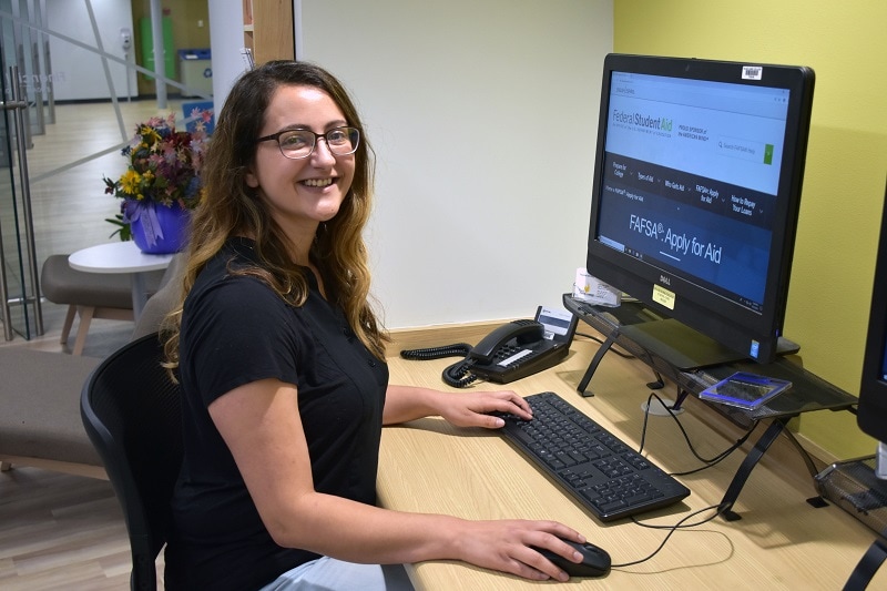 student at a computer with FAFSA website pulled up