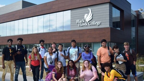 students pose in front of the Building 1 addition