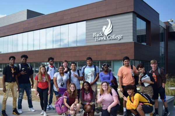 students pose in front of the Building 1 addition