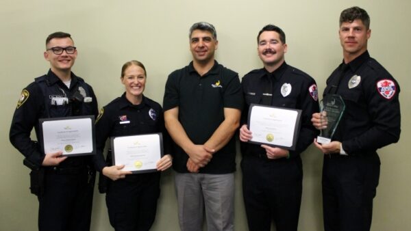 Seref Onder with 4 police officers holding certificates & award