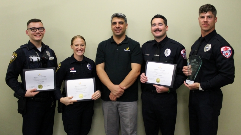 Seref Onder with 4 police officers holding certificates & award